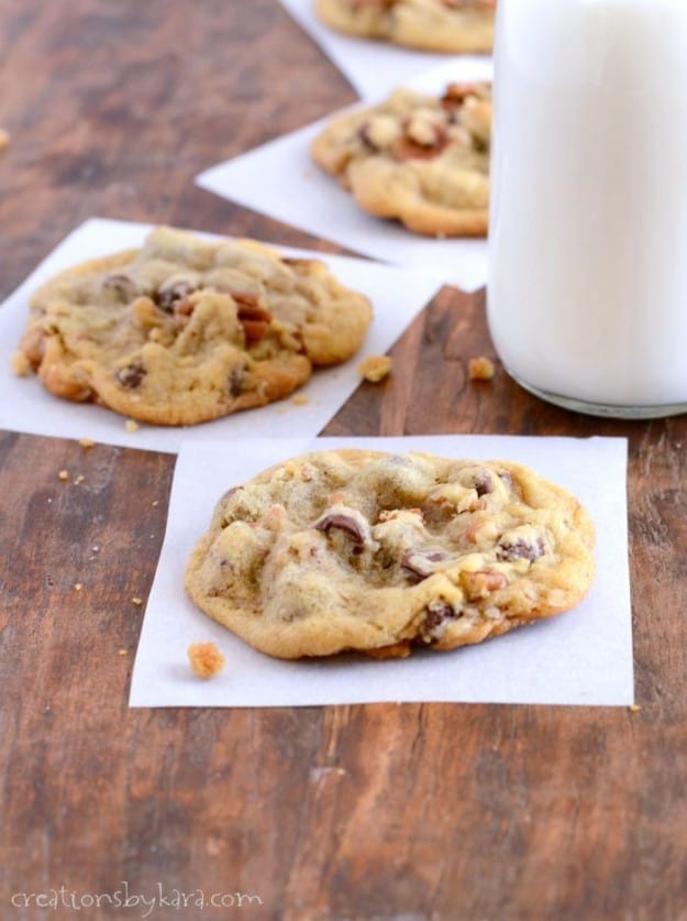 Chocolate Chip Cookies on waxed paper with a glass of milk