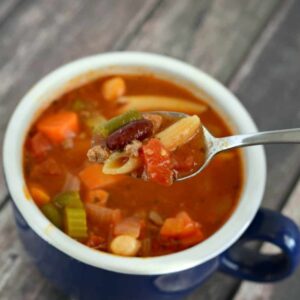 With ground beef, beans, veggies, and pasta, this Minestrone Soup recipe is hearty and delicious!