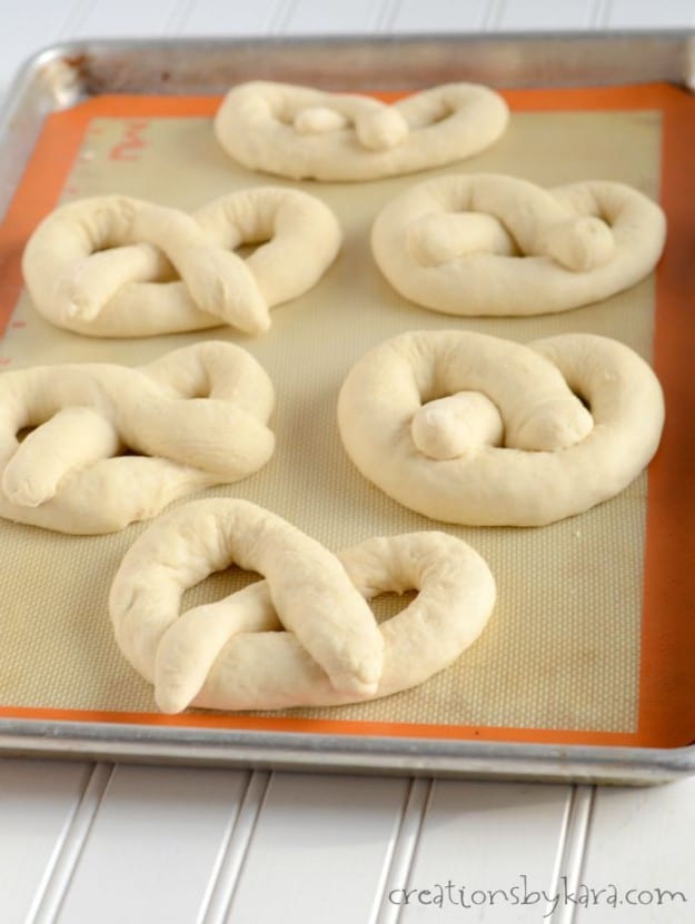 uncooked soft pretzels on a cookie sheet