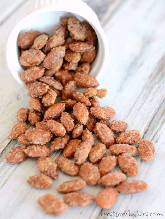 almonds coated with cinnamon sugar pouring out of a bowl