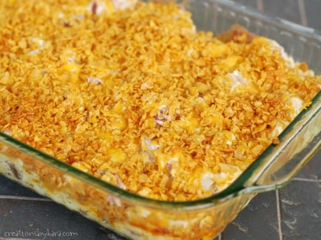 pan of cheesy potatoes topped with crushed cornflakes