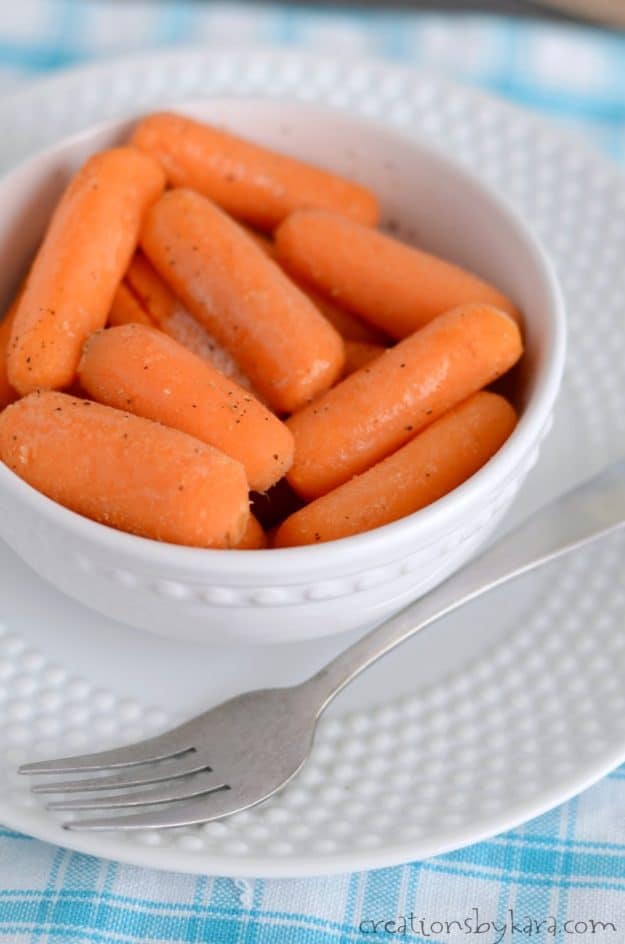 bowl of sweet cooked carrots with a fork