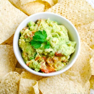 bowl of homemade guacamole with tortilla chips