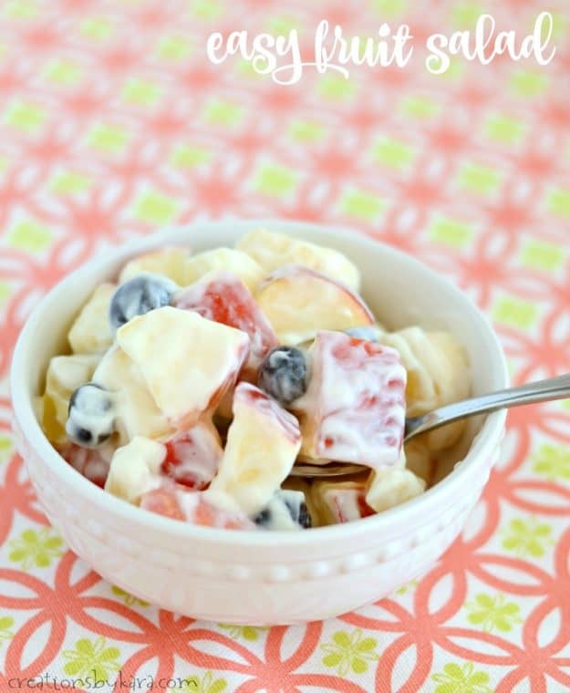 bowl of fruit salad glazed with sweet creamy sour cream sauce