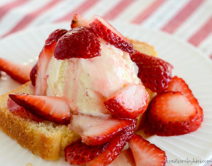 plate of pound cake topped with vanilla ice cream and sugared strawberries