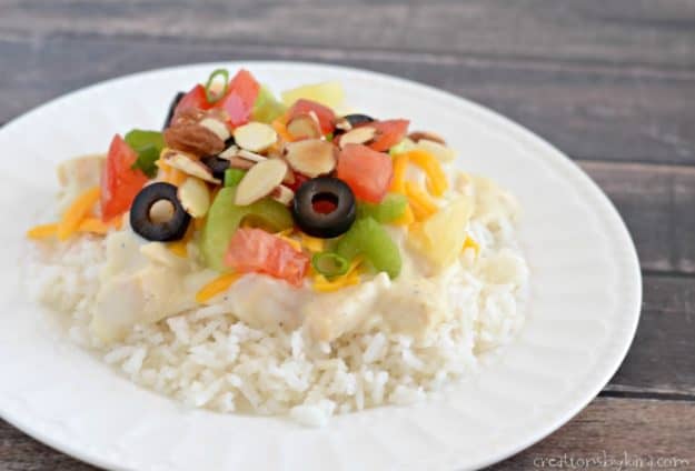 plate of rice with creamy chicken sauce and toppings