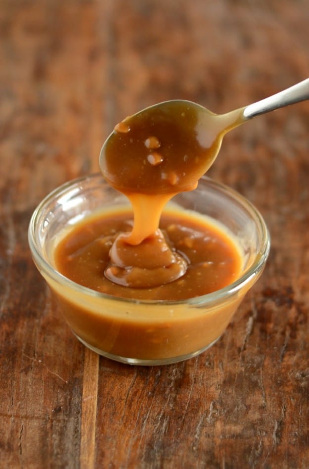  Peanut Butter Sauce being dripped from a spoon into a bowl