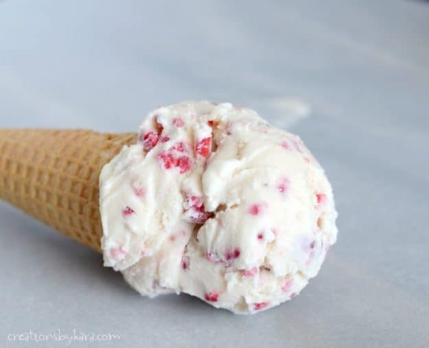 close up of ice cream cone with homemade raspberry ice cream
