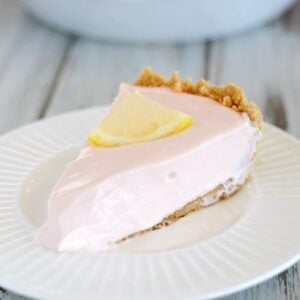 A creamy slice of pink lemonade pie - the perfect summer dessert!