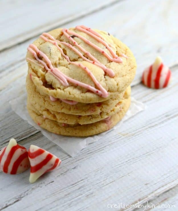 stack of chocolate chip cookies with candy cane peppermint hershey kisses