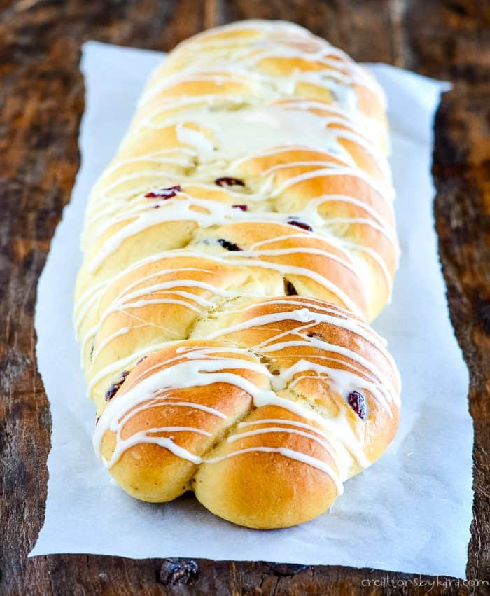 Soft and tender, this cranberry eggnog bread is a must make at our house every holiday season! #cranberryeggnogbread #cranberryeggnogbraid #christmasbread #creationsbykara #craisins braided yeast bread with cranberries and eggnog glaze
