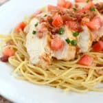 Chicken and Pasta with a light lemon sauce and bacon. Garnished with tomatoes and green onions, this is a colorful and delicious chicken recipe!