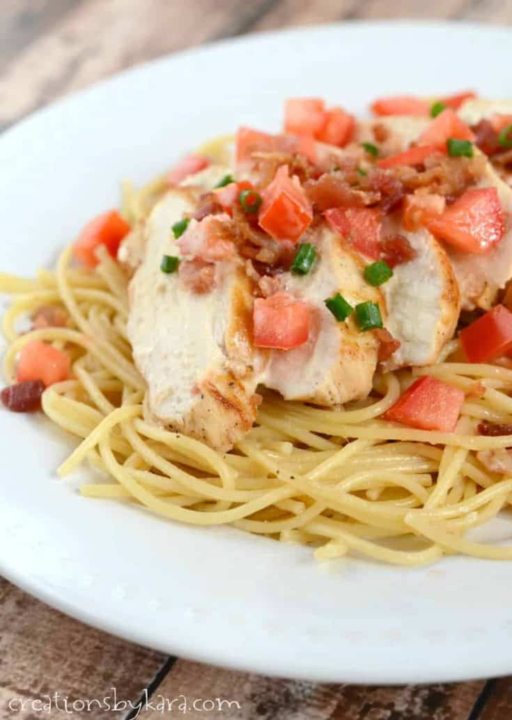 Chicken and Pasta with a light lemon sauce and bacon. Garnished with tomatoes and green onions, this is a colorful and delicious chicken recipe!