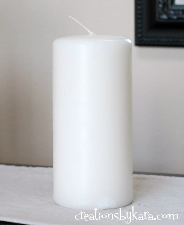 adding yarn to white pillar candle