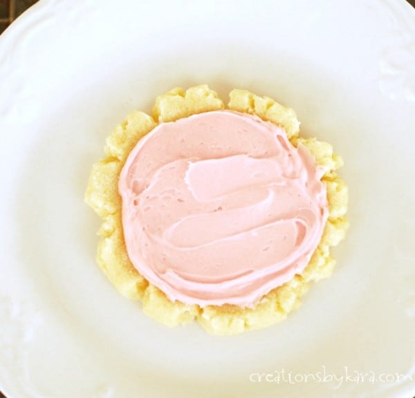 overhead shot of sugar cookie frosted with pink frosting