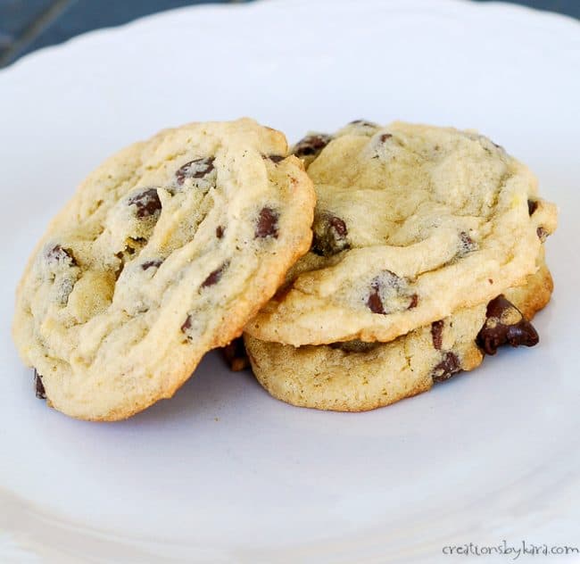 stack of three soft chocolate chip cookies on a plate