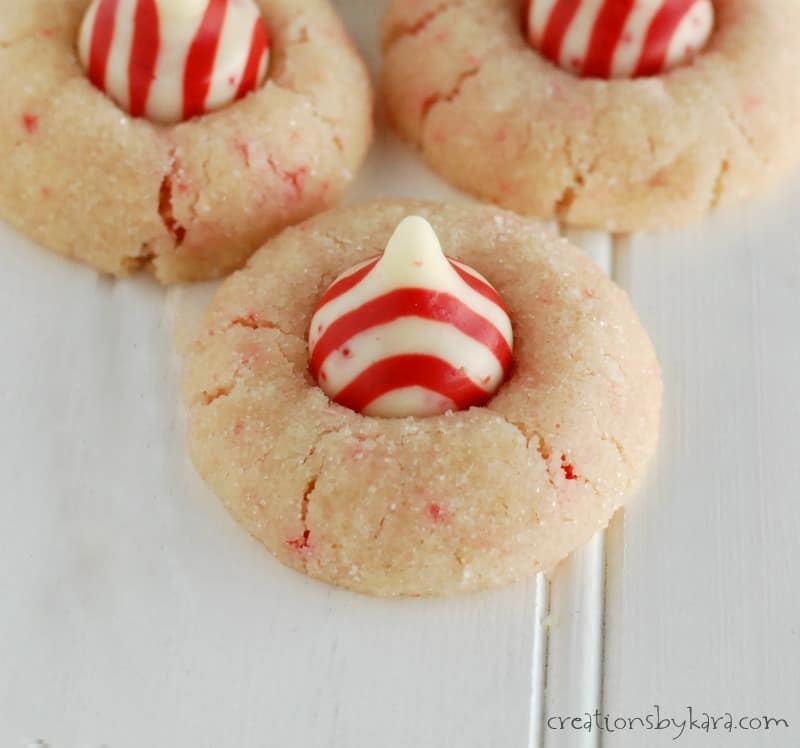 candy cane shortbread cookies topped with a peppermint hershey kiss