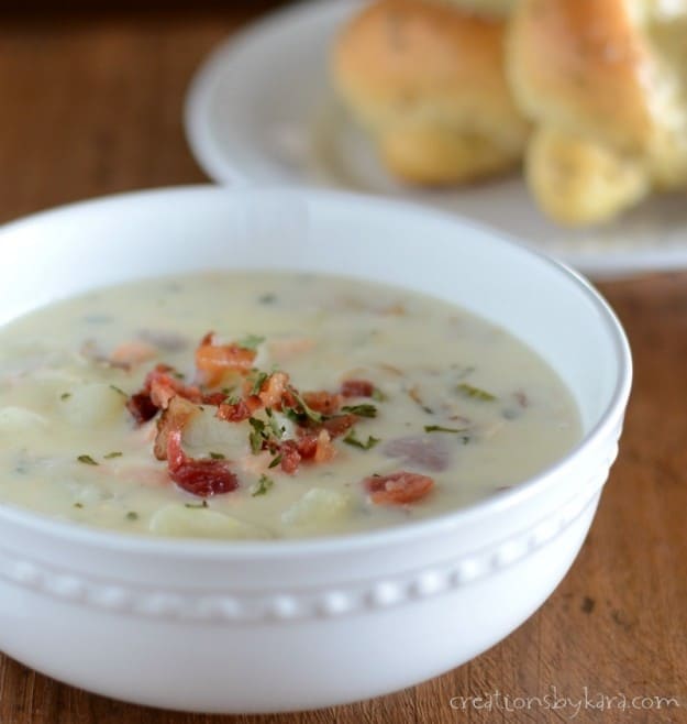 bowl of Salmon Chowder with breadsticks in the background
