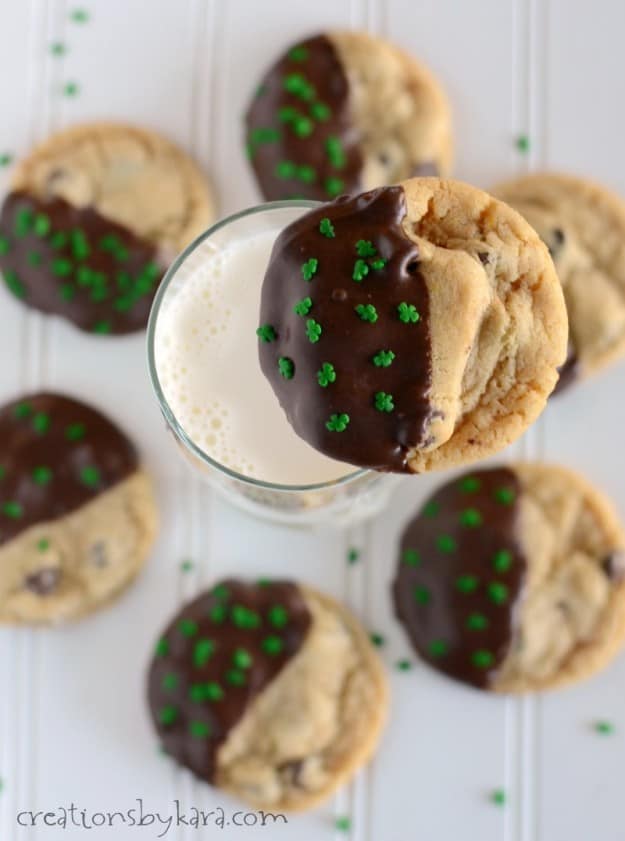 cookie dipped in chocolate over a glass of milk