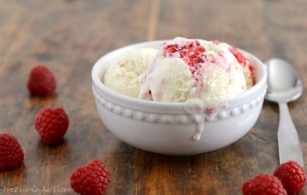 bowl of no churn white chocolate ice cream with raspberry swirl