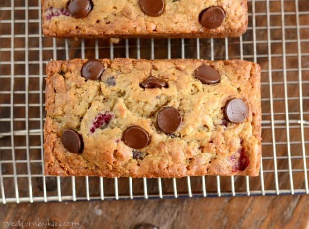 Chocolate Chip Banana Bread with Raspberries on a cooling rack