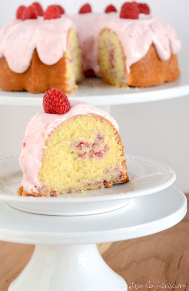 slice of raspberry swirl bundt cake on a white plate