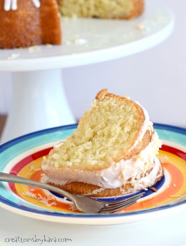 slice of coconut cake on a plate with a fork