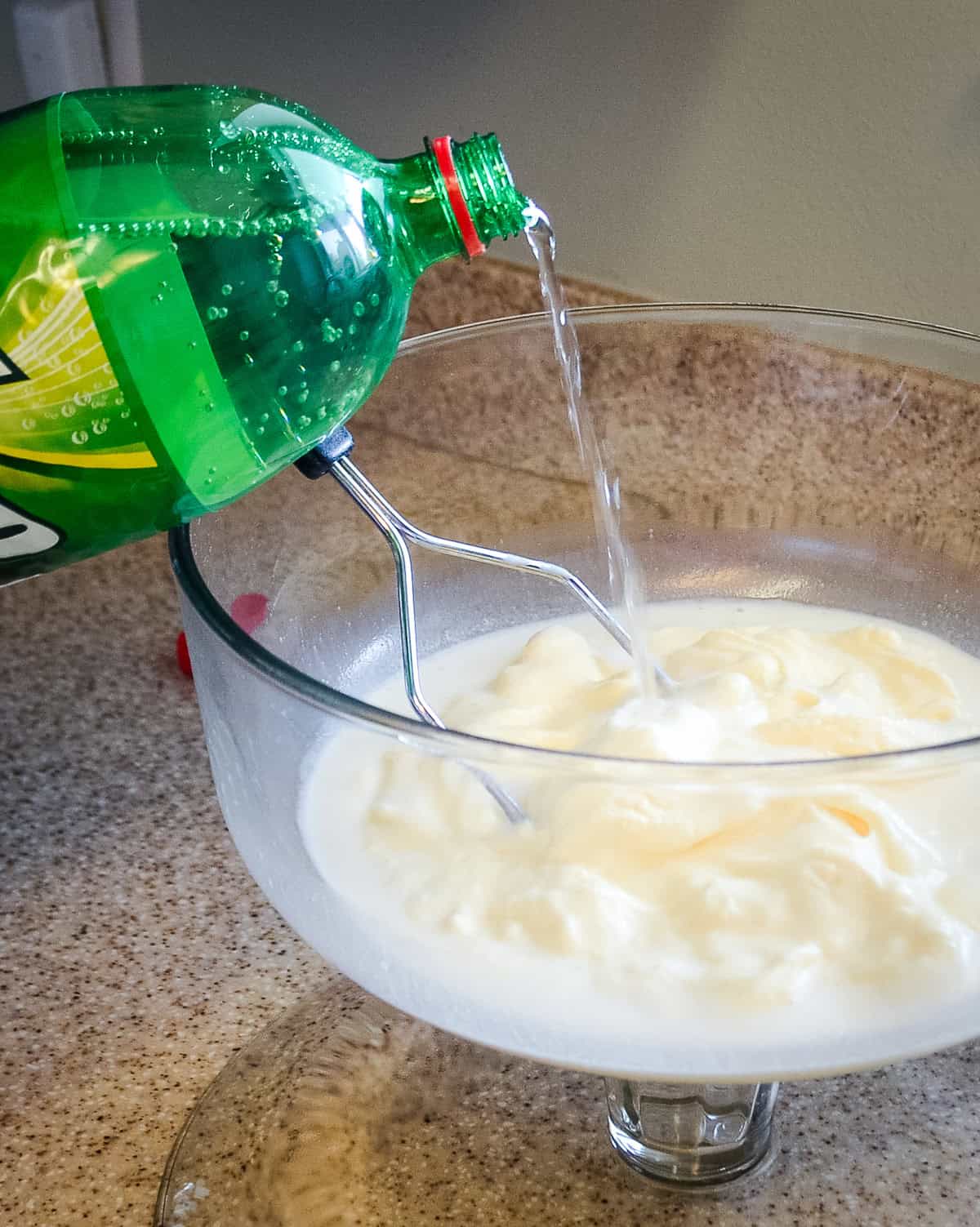 pouring 7-up into white punch
