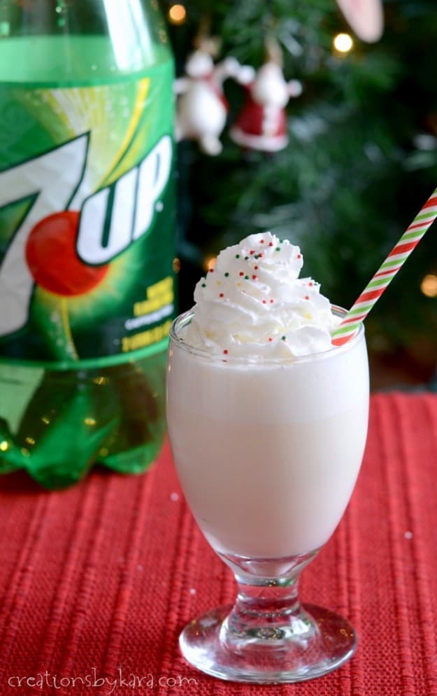  creamy Christmas punch topped with whipped cream and sprinkles 