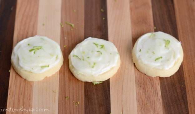 shortbread cookies topped with lime frosting and lime zest