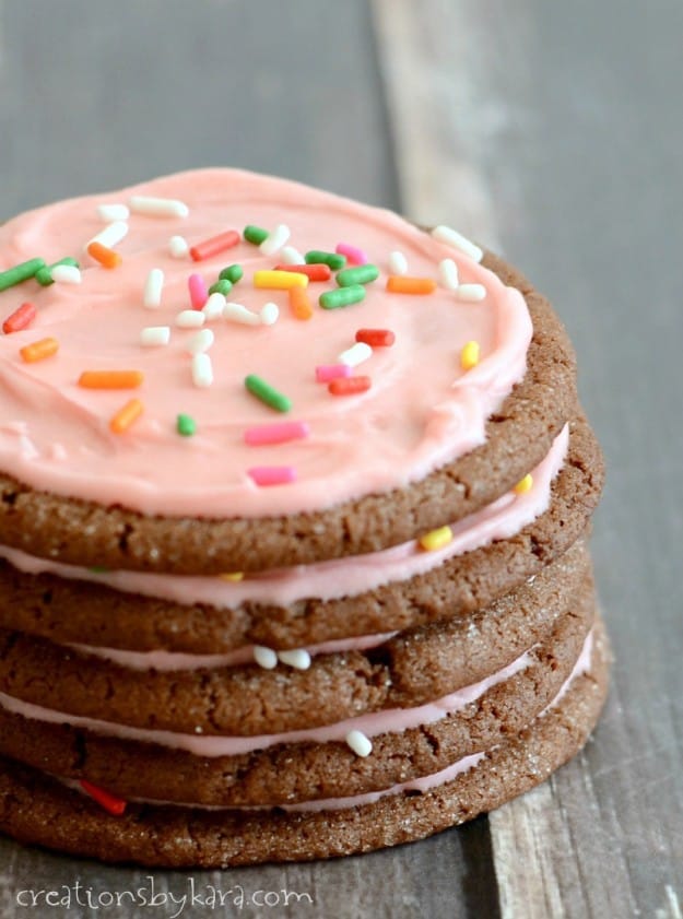 stack of chocolate cookies with pink frosting