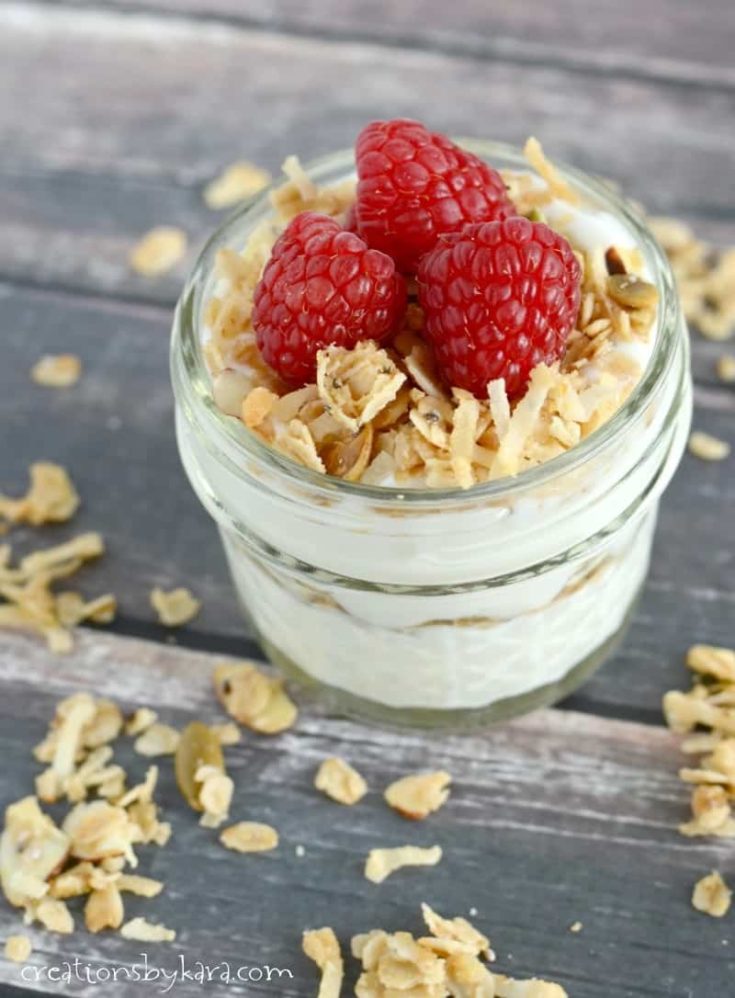Homemade granola with yogurt and fresh raspberries. Perfect for breakfast or snacking!