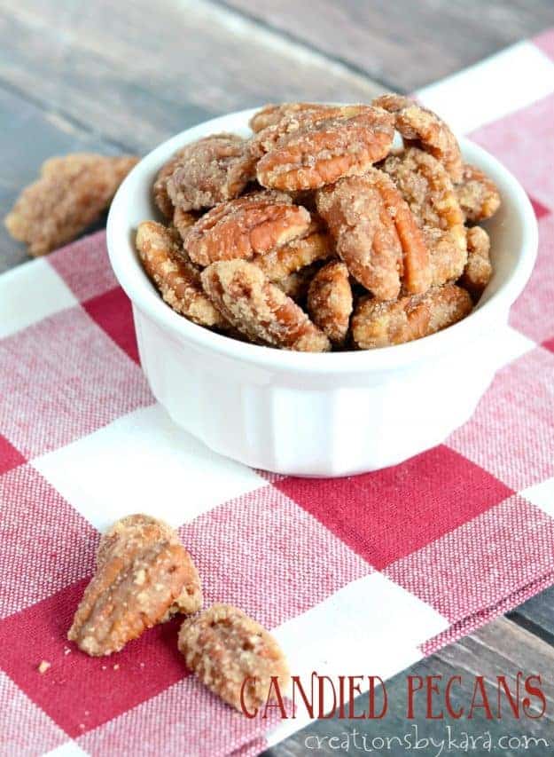 bowl of candied pecans on a red checkered cloth