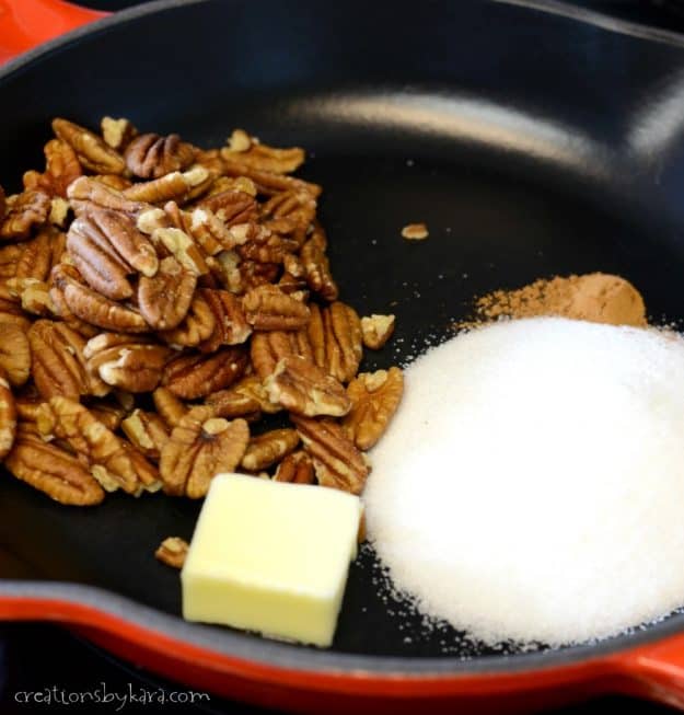 skillet with ingredients for making candied pecans
