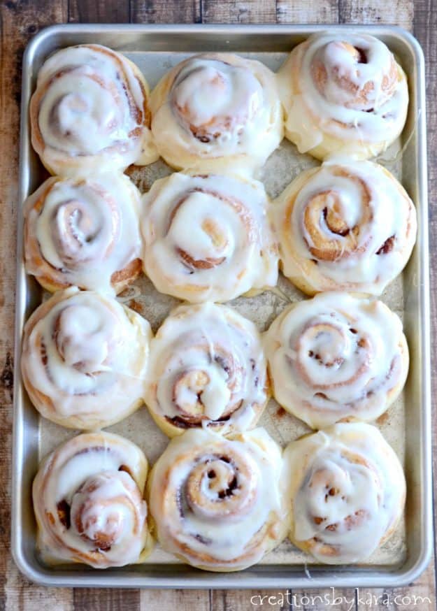 sheet of ooey gooey one hour cinnamon rolls with frosting