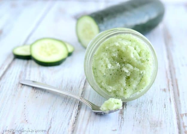 Jar of cucumber mint sugar scrub with a spoon
