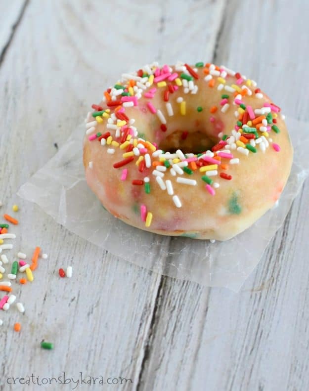 donut with sprinkles on a piece of waxed paper