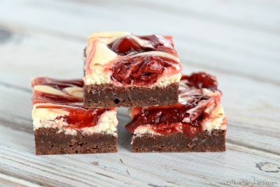Fudgy brownies topped with cheesecake and a cherry swirl. Such a yummy dessert recipe.