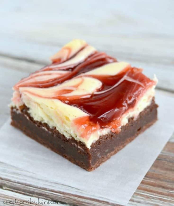 cheesecake brownie with cherry swirl on a piece of waxed paper