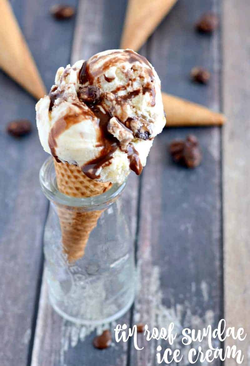 homemade tin roof ice cream with chocolate sauce and chocolate covered peanuts in a cone