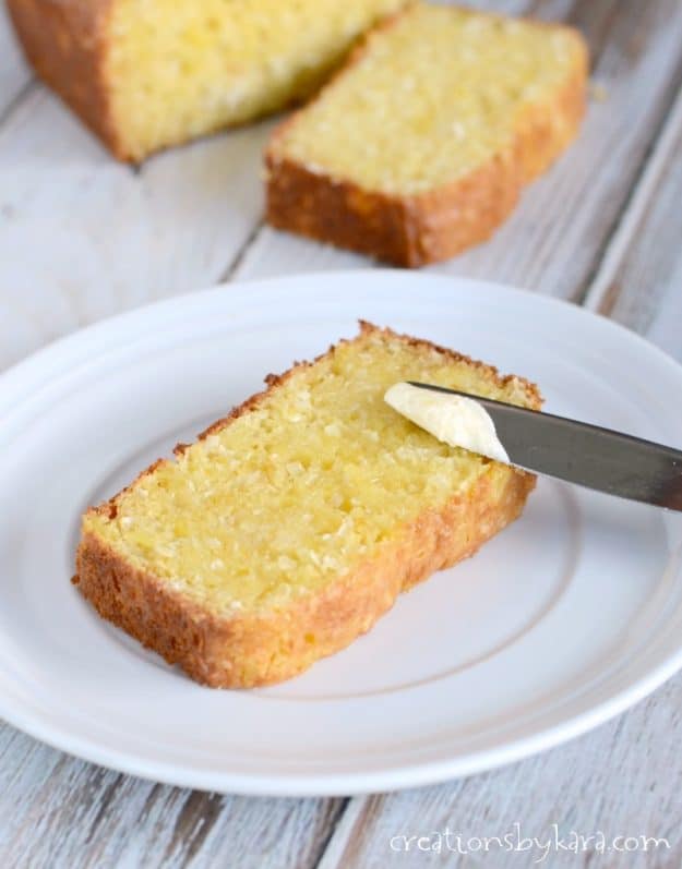 butter being spread on a slice of toasted pina colada bread