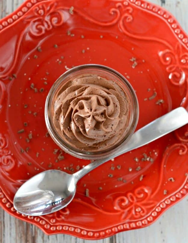overhead shot of mousse in a mason jar with a spoon