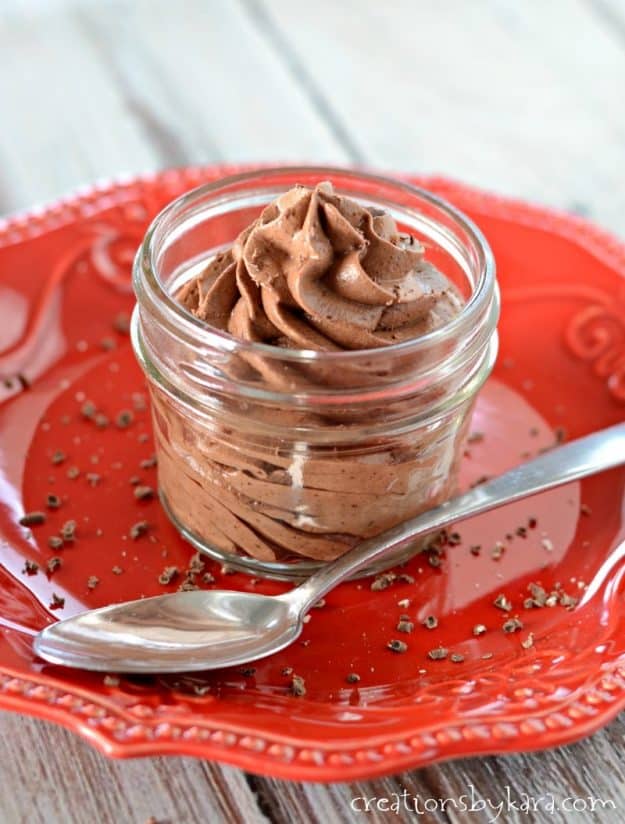 mousse piped into a mason jar on a red plate