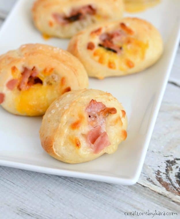 close up of soft pretzel bites stuffed with ham and cheese.