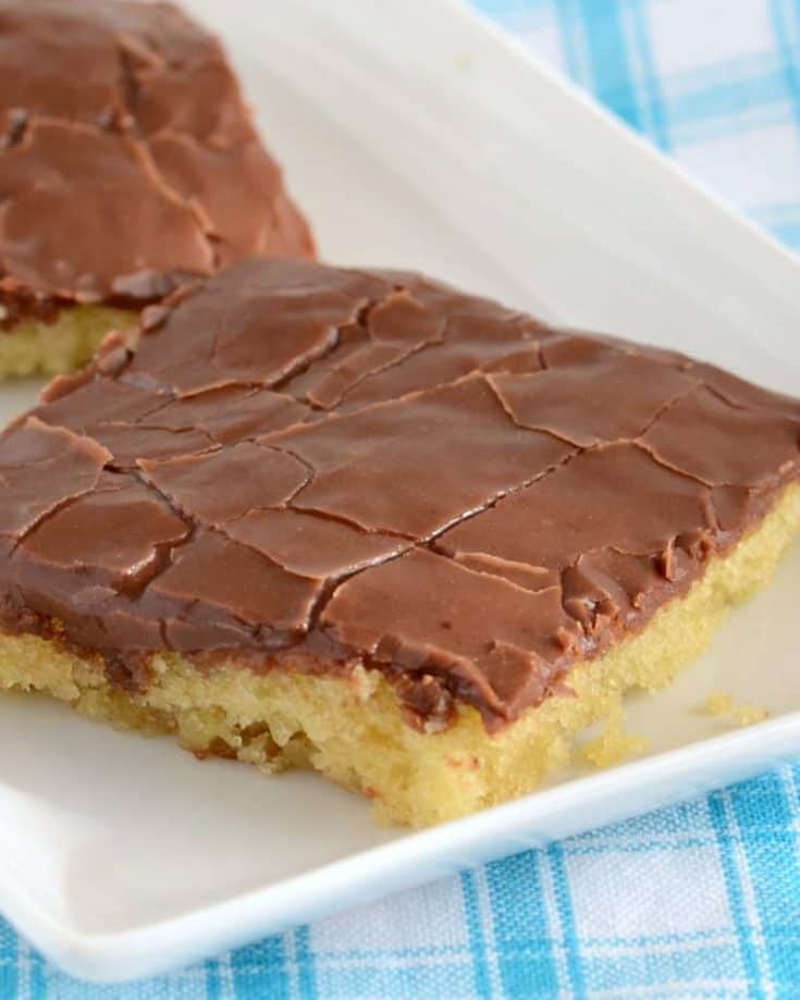 The chocolate fudge frosting makes this yellow sheet cake irresistible! A crowd pleasing cake recipe.