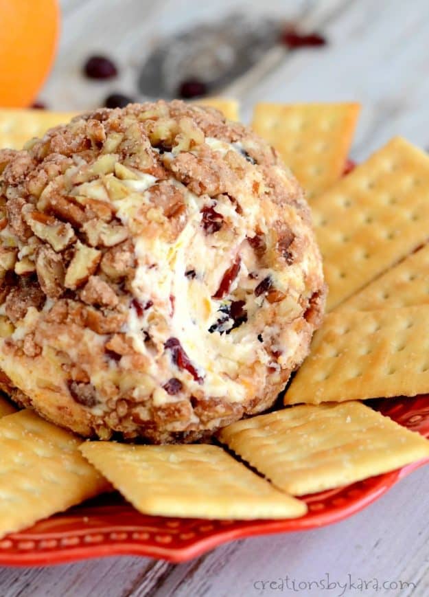 close up of cheese ball with cranberries and sugared pecans