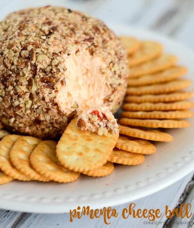 pimento cheese ball on a plate with crackers