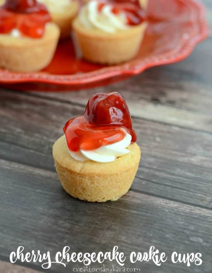 Mini Cherry Cheesecake Cookie Cups - tasty cherry cheesecake in bite sized form. Perfect for parties! #minicheesecake #cookiecups #cherrycheesecake