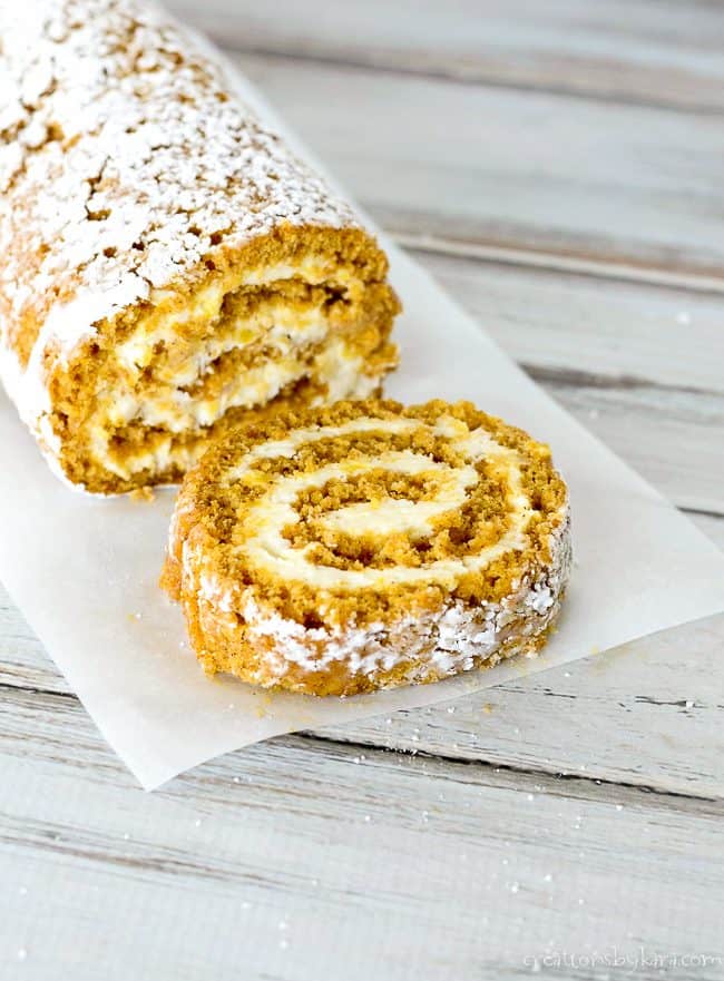 pumpkin roll sliced on parchment paper