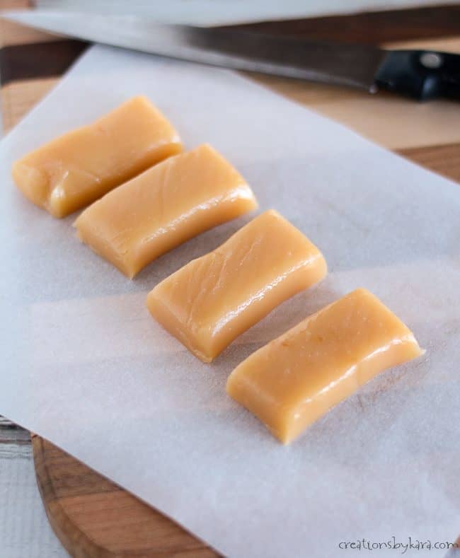 microwave caramels on a cutting board with a knife